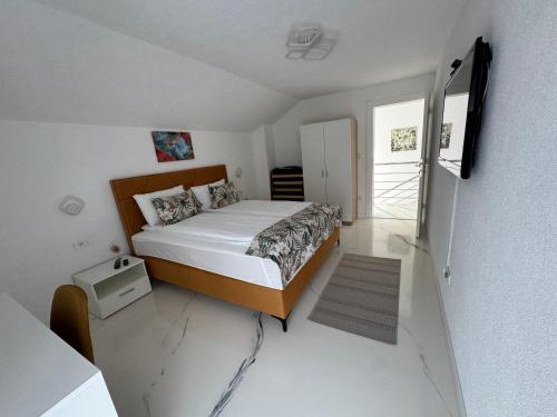 a small bedroom with a bed and a window at AM Una Lux House in Bihać