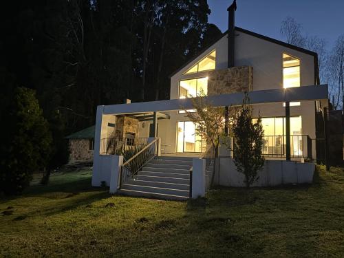 a house with a staircase in front of it at Nest On Thula in Dullstroom