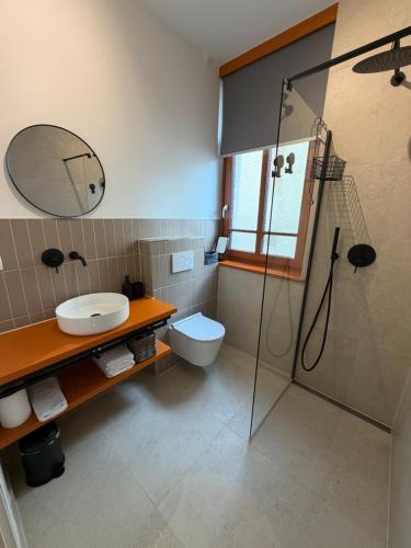 a bathroom with a toilet and a sink and a shower at Street Apartment Rombon in Bovec