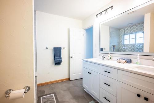a bathroom with a white sink and a mirror at Private Luxury Getaway | Fire Pit | Near Weddings in Dripping Springs