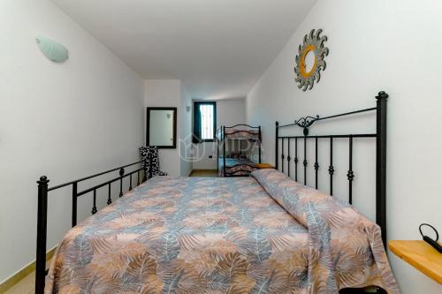 a bedroom with a bed and a clock on the wall at Arabic Sea Apartments in Porto Cesareo