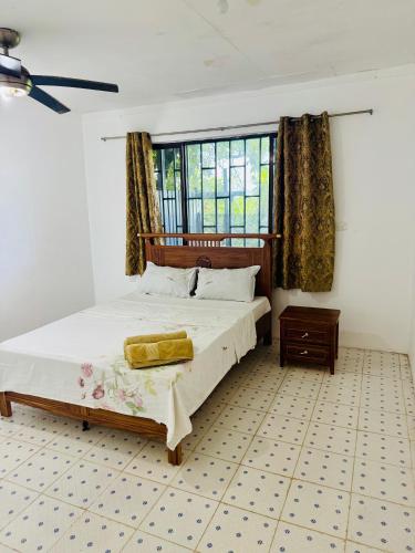 a bedroom with a bed and a large window at Three bedroom apartment in Suva