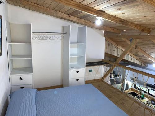 a bedroom with white shelves and a bed at Almonte House in Puerto Plata