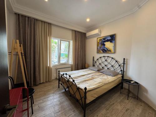 a bedroom with a bed and a large window at RestCoast Villa in Shekhvetili