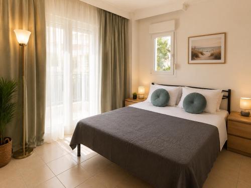 a bedroom with a bed and a large window at Odyssey Mare Steps from the Sea in Perea