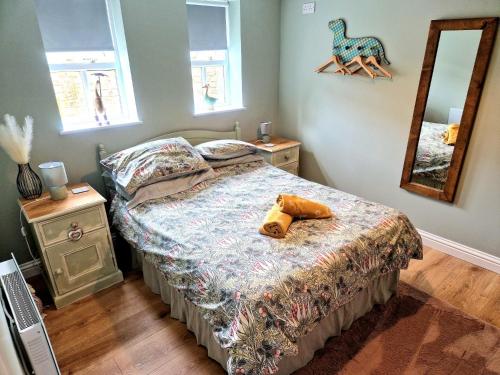 a bedroom with a bed and a mirror at The Stables Annexe in Patrington