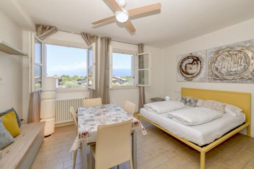 a bedroom with a bed and a table and chairs at Baldo View Studio in Toscolano Maderno