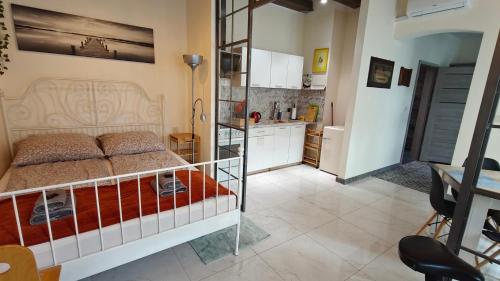 a bedroom with a bed and a kitchen at La La Loft in Bytom