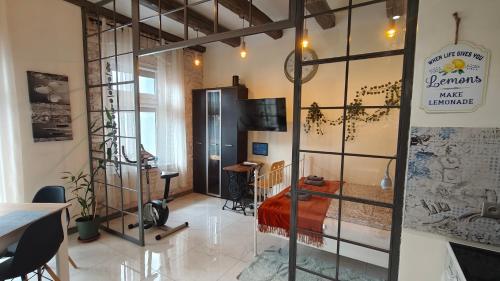 a room with a bed and a glass wall at La La Loft in Bytom