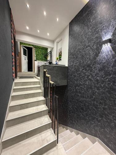 a staircase in a house with a black wall at Villa Mešić in Stojčevac