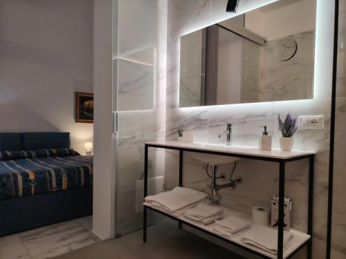 a bathroom with a sink and a mirror at FALSTAFF Rooms & Suites in Palermo