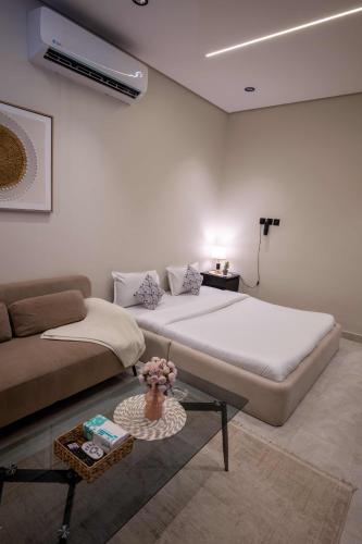 a living room with a bed and a couch at استديو خاص in Al Khobar