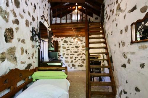 a room with two bunk beds and a staircase at Angela's River Paradise Cottages in Mixórrouma
