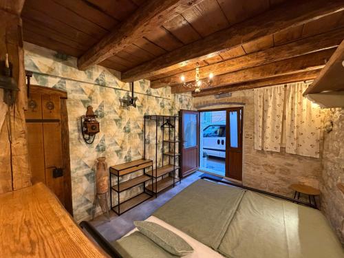 a bedroom with a bed in a room with stone walls at Studio apartman Ema in Umag
