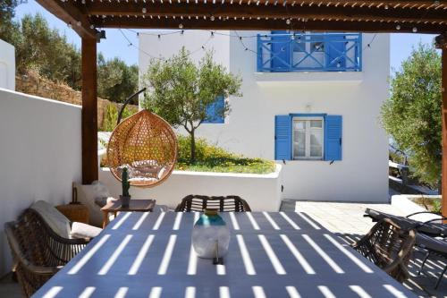 a patio with a blue table and chairs at Villa Giulia, Seaview Villa near Chora in Ios Chora