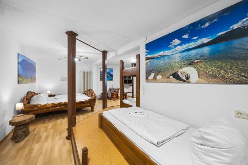 a bedroom with two beds in a room with a painting at Gästehaus Parkblick in Rust