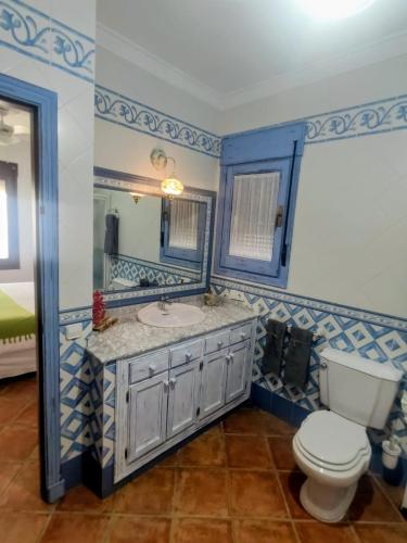 a bathroom with a sink and a toilet at "La Güena Vida" Chalet con 4 Habitaciones de Hotel in Algodonales