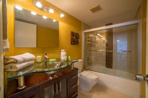 a bathroom with a glass sink and a shower at Oceanfront 5th Floor Penthouse in Key Largo
