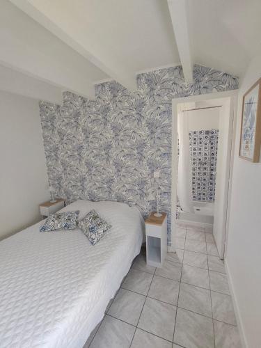 a bedroom with a bed and a wall mural at la crique in Sisco