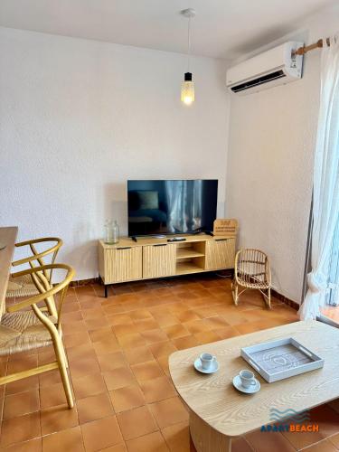 a living room with a large flat screen tv at APARTBEACH BALANDRO VISTAS MAR in Cambrils