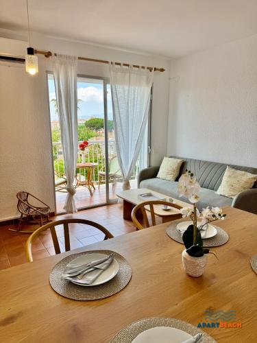 a living room with a table and a couch at APARTBEACH BALANDRO VISTAS MAR in Cambrils
