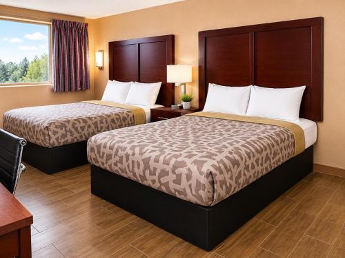 a hotel room with two beds and a window at Overlook Mountain Inn in Guntersville