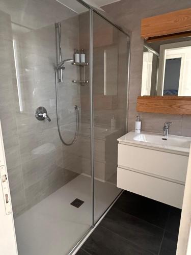a bathroom with a shower and a sink at Lake Como Serenity Suite in Lierna