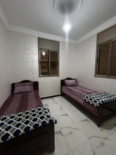 a bedroom with two beds in a room at Villa zaytoun in Agadir
