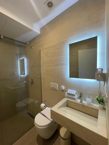 a bathroom with a toilet and a sink and a shower at Solea Hotel in Vlorë