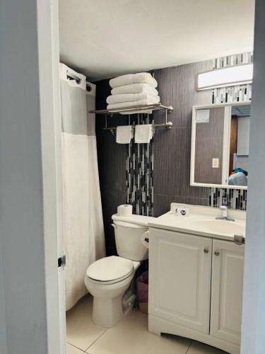 a bathroom with a white toilet and a sink at Renovated Beachfront Condo with Balcony in Sunny Isles Beach