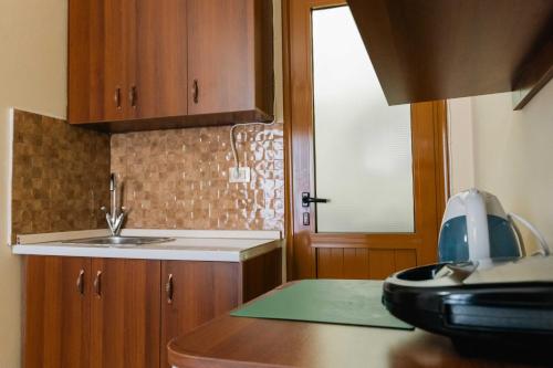 a kitchen with a sink and a counter top at Kalpazo Rental Kaya Stays in Golem