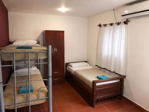 a small room with two bunk beds and a window at El Zorro Cabin Nature and Relaxation near Salta in Salta