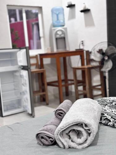 a pair of towels sitting on top of a bed at La Isla Studio - Quimixto in Qumiste