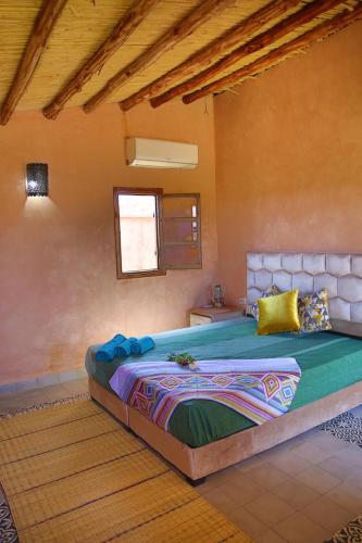 a bedroom with a large bed in a room at Dômes et Bangalows traditionnel in Marrakesh