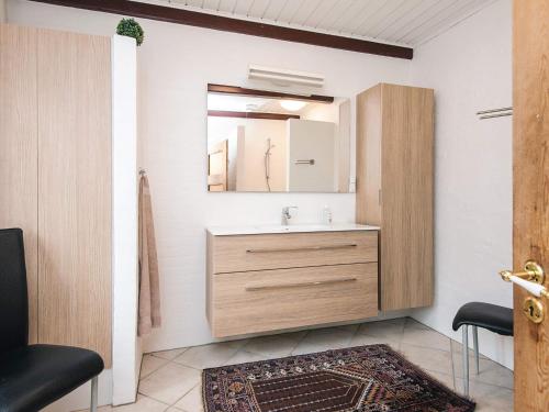 a bathroom with a sink and a mirror at 4 star holiday home in Hornsyld in Hornsyld