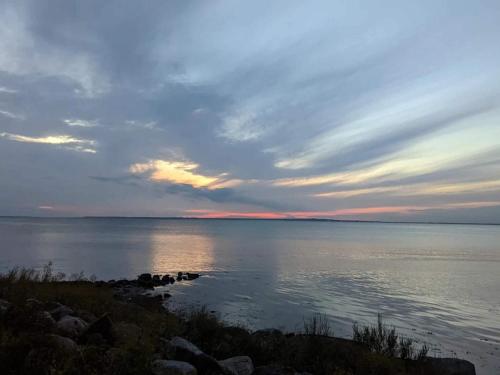 a view of a large body of water at sunset at Bogense Ferieboliger 500 m til kysten in Bogense