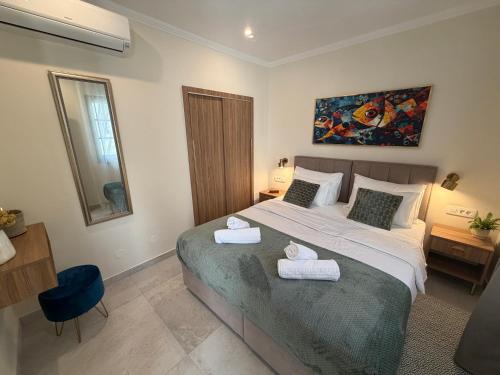 a bedroom with a large bed with two towels on it at Heritage Villa Francheza-Elegant Stone villa near the Beach, Pašman Island , Ugrinić in Ugrinići