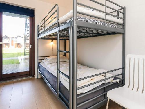 a bunk bed room with two bunk beds and a window at 4 person holiday home in Bogense-By Traum in Bogense