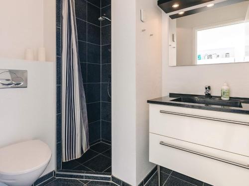 a bathroom with a toilet and a sink at 4 person holiday home in Bogense-By Traum in Bogense