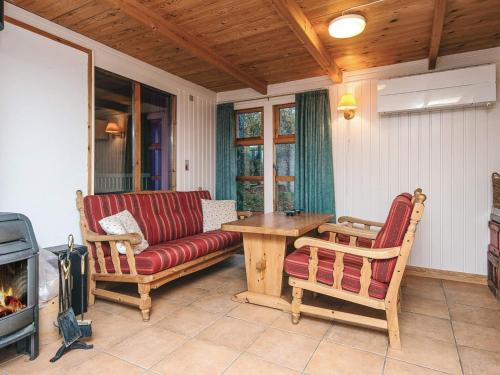 a living room with a couch and a table at 7 person holiday home in Kolind in Kolind