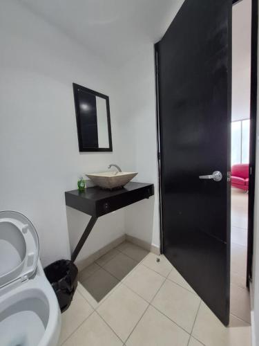 a bathroom with a sink and a toilet at Modern apartment Altravia 6 tower in Cholula