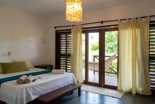 a bedroom with a bed and a sliding glass door at Villa Piauí in Barra Grande