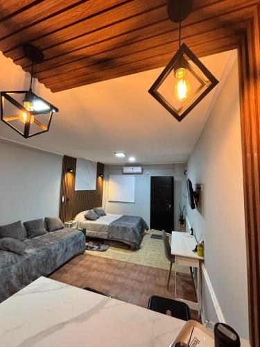 a living room with a couch and a bed at Urban Berazategui in Berazategui