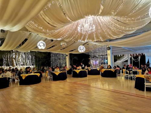 a banquet hall with a large white tent with people sitting at Hotel & Balneario Los Angeles in Taxco de Alarcón