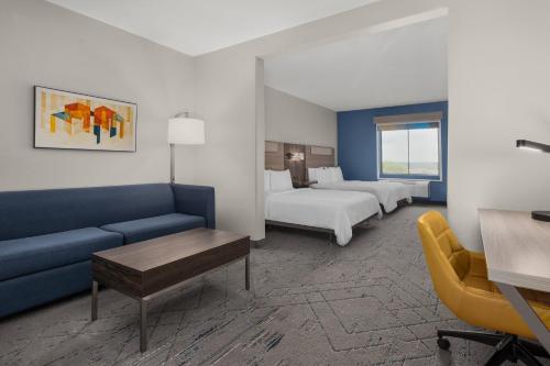 a hotel room with a couch and two beds at Holiday Inn Express Marble Falls by IHG in Marble Falls