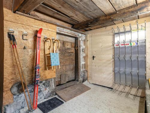 a room with skis and ski poles on the wall at Bühelhus in Dalaas