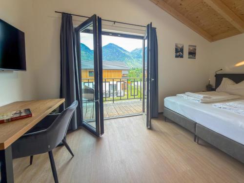 a bedroom with a bed and a desk and a window at Obermöschach 1B in Lake Pressegg