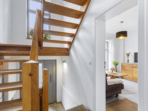 a staircase in a home with white walls and wooden stairs at Lee in Wismar