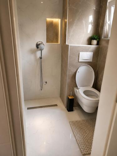 a small bathroom with a toilet and a shower at Vila Dar Selam halal-friendly in Mostar