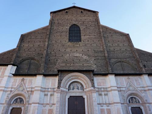 a large church with a tall building with a tower at Casa Isolani Luxury Rooms Piazza Maggiore in Bologna